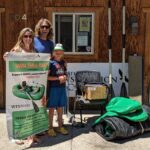 Clay Farland and family pose with rolled up Hyside MiniMax raft and accessories