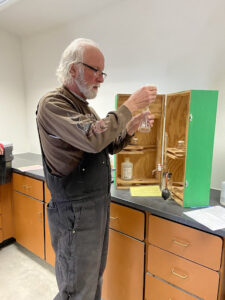 man conducting a chemistry test on a water sample